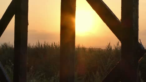 A-view-of-the-sunset-through-the-gates-in-a-summer-day