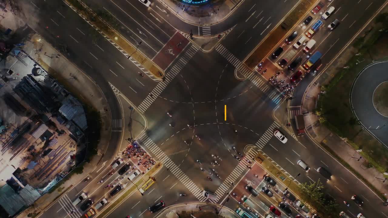 City Intersection at Night with Traffic and People