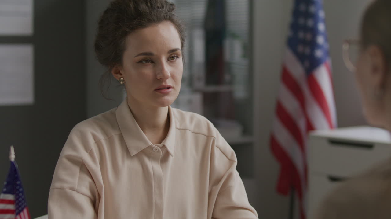 Woman Having Conversation with Consular Officer during US Visa Interview