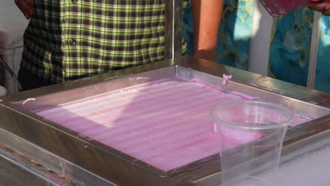 making cold rolled ice cream at a street stand