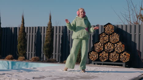 woman dancing in the snow by the pool