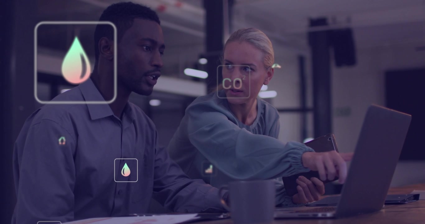 Diverse Business Team Analyzing Environmental Data on Laptop