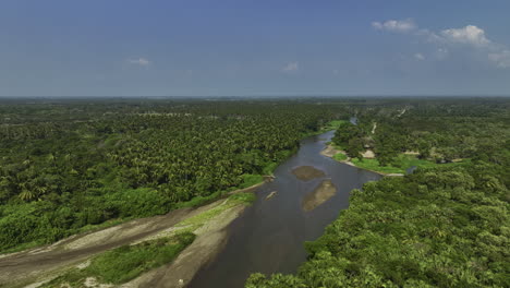 aerial flyover a river in middle of mangrove woods, in barra san jose, mexico