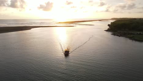 the-aerial-view,-the-boats-sailing-in-the-lagoon-at-sunset-looks-very-beautiful