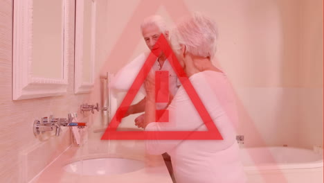 triangle warning sign over seniors washing hands in the background. covid-19 spreading