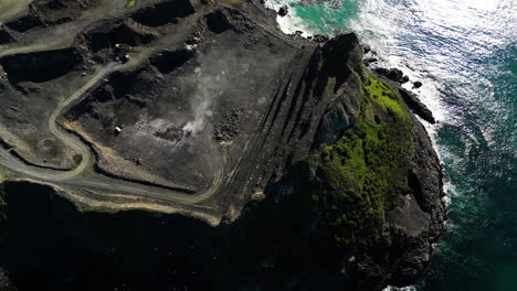 aerial panning top down view of blackhead quarry in the coast of dunedin, new zealand
