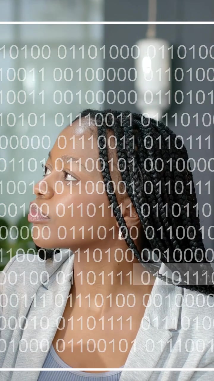Vertical video: Woman with braids following offscreen cue, watching binary overlay for tech review
