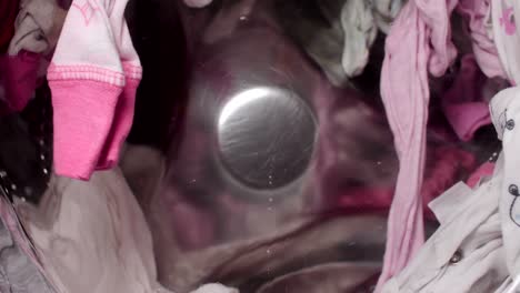 close up at rotating laundry in washing machine.