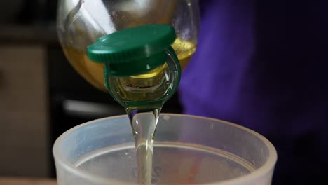 pouring oil into bowl for homemade cooking. homemade kitchen concept