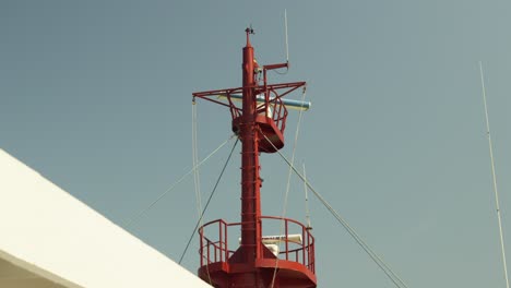 hand-held shot of a ferries radar and communication systems spinning