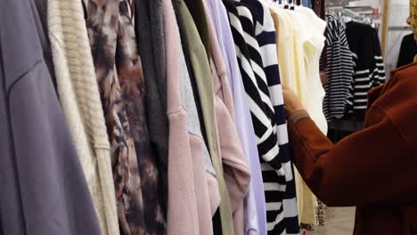 woman shopping for clothes in a clothing store