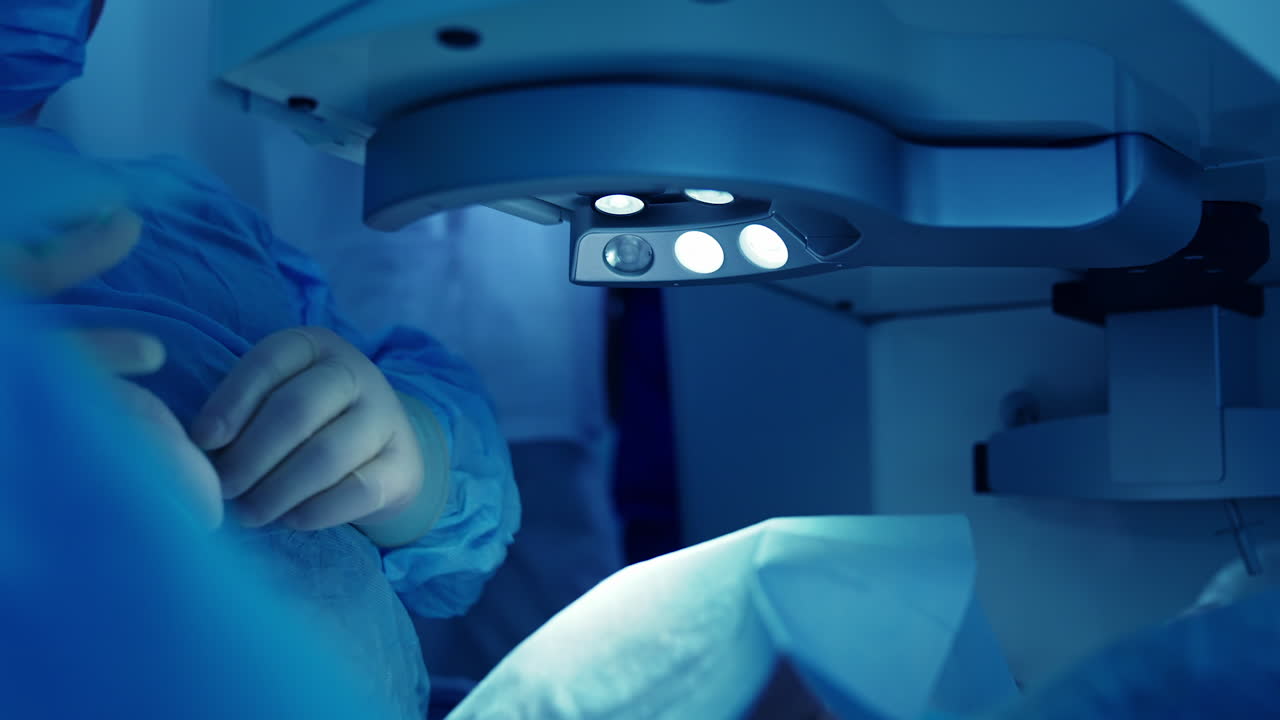 Ophthalmological equipment during eye surgery. Laser correction on eye. Doctor using microscope for treatment of cataract and diopter correction in the operating room. Blue light.