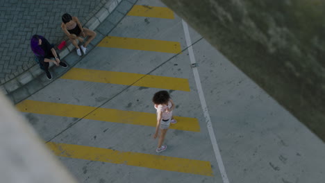 dancing-woman-young-street-dancer-with-afro-performing-contemporary-moves-friends-watching-enjoying-urban-freestyle-dance-in-city-overhead-view