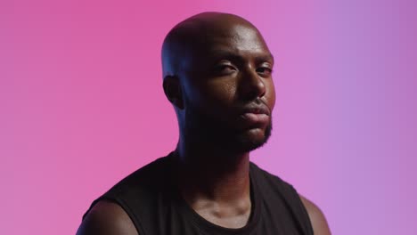 Studio-Portrait-Shot-Of-Male-Athlete-Wearing-Sports-Vest-Against-Pink-Lit-Background-3