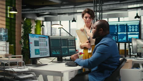 vertical video multiethnic work team consulting each other in completing monthly reports