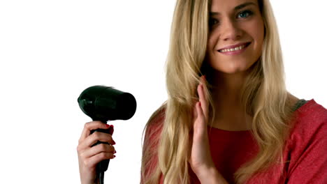 la rubia se está secando el cabello.