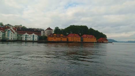 colourful buildings at bergen city harbour while on a sightseeing boat in norway.