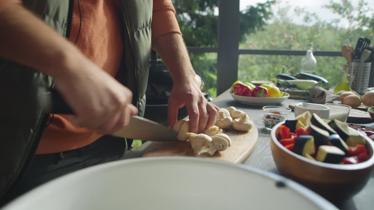 Man Cutting Champignons on Outdoor Terrace