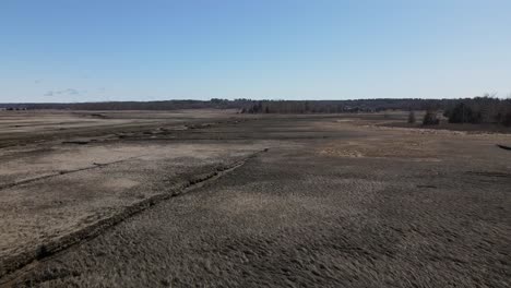 aerial flyover of a tidal salt marsh during a sunny day with bright blue sky in scituate,massachusetts