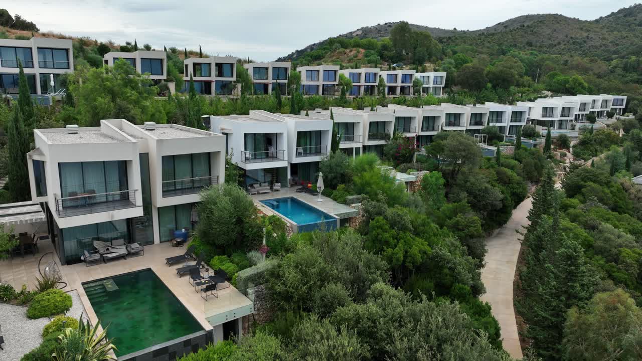 Modern hillside villas with pools in Saranda, Albania, surrounded by lush nature