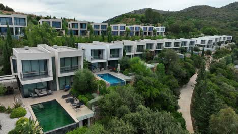 modern hillside villas with pools in saranda, albania, surrounded by lush nature