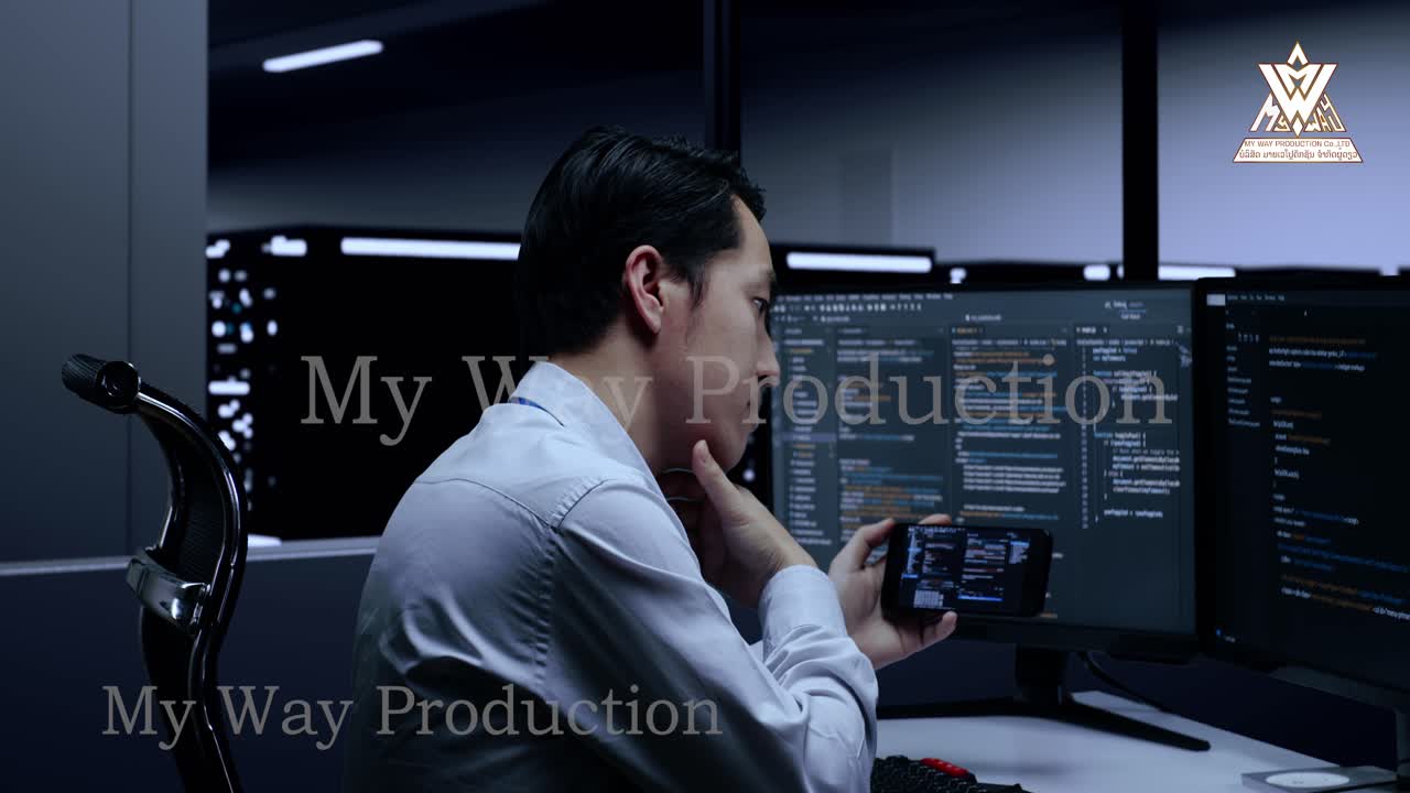 Man working on computers in a server room