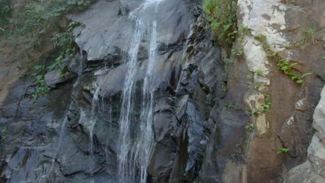 water flowing down to rocky cliff of cascada de yelapa in jalisco, mexico