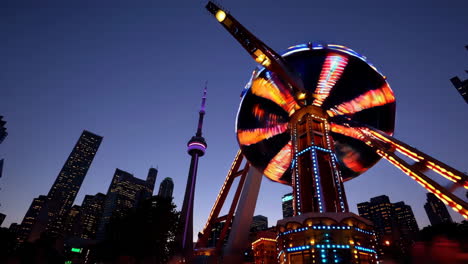 toronto skyline at night with amusement park ride