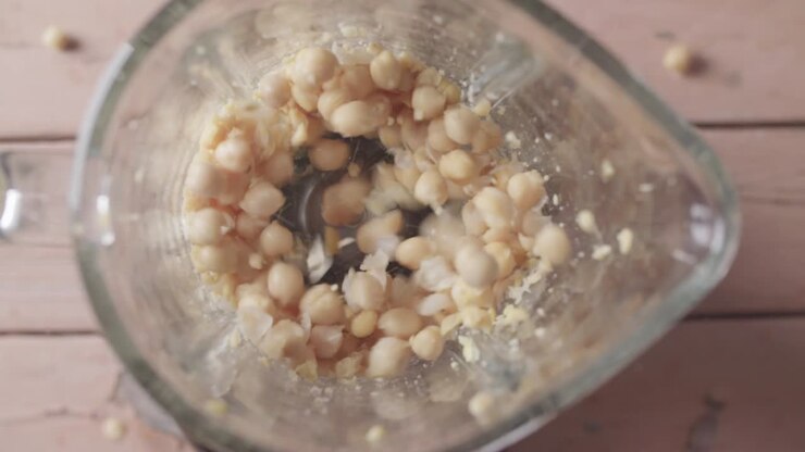 Chickpeas being blended in blender