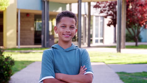 Mixed-race-schoolboy-walking-to-camera-outside-school