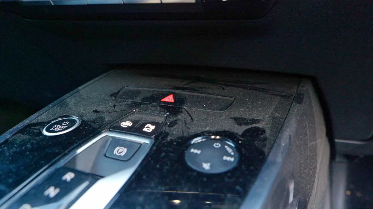 Extremely dusty black centre consol - close up - truck pan left to right