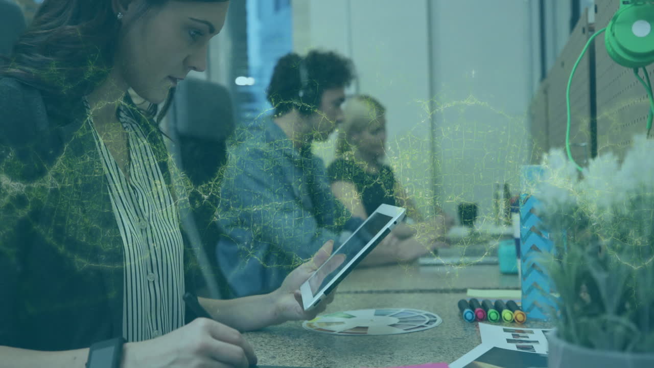 Team collaborating on graphic design projects in business office, overlaying animated color wheel