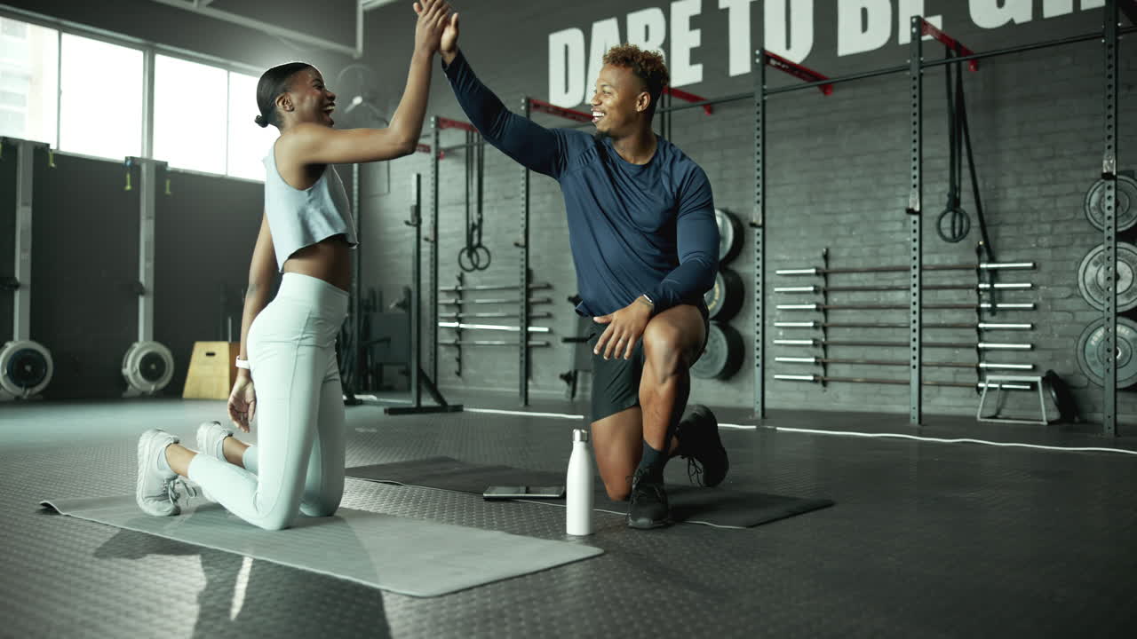 A fit couple exercising together in a gym