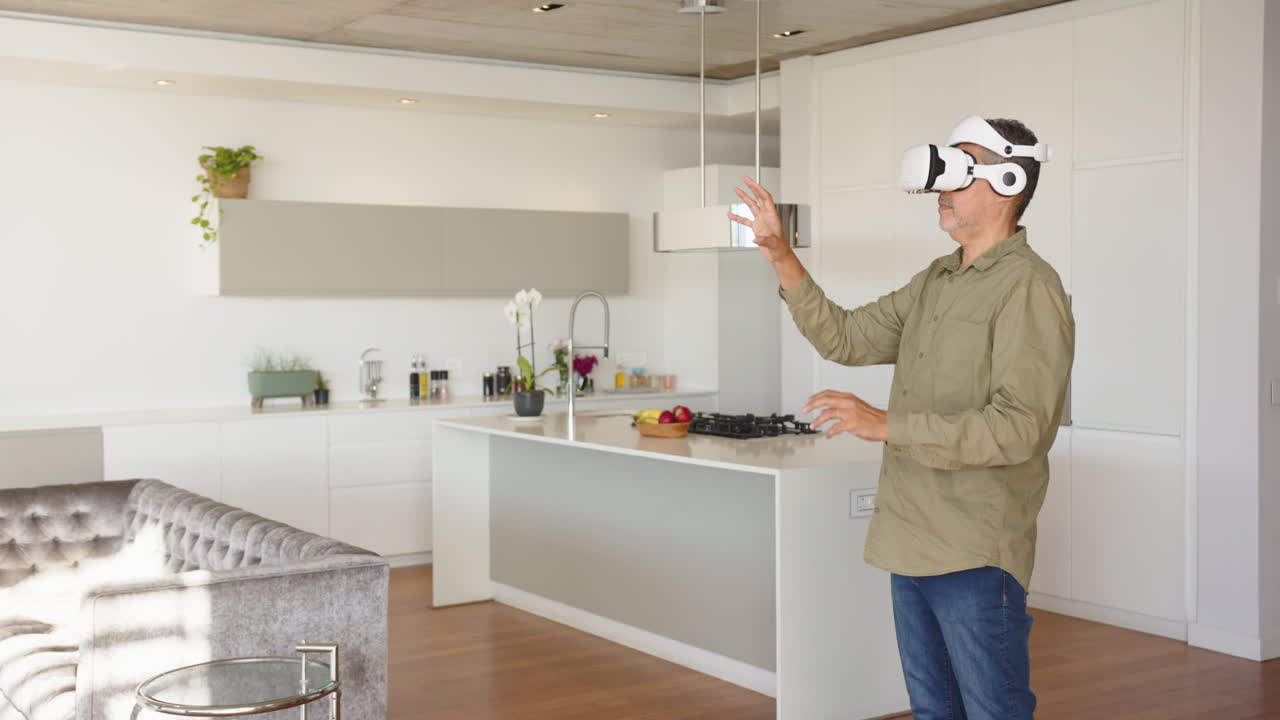Using VR headset, man exploring virtual reality in modern kitchen, at home, copy space