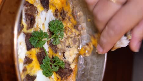 hand picking a piece of delicious turkish dish
