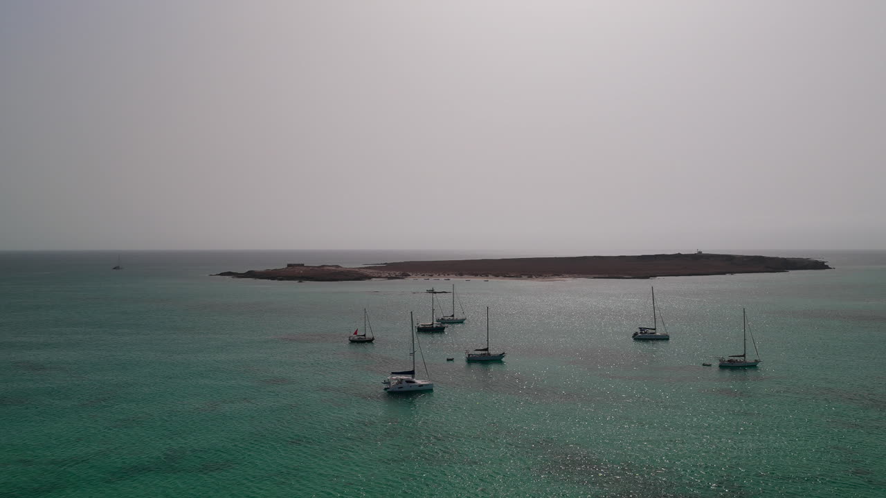 Aerial view of many luxury yachts moored in the bay of Sal Rei city, background the Island of Djeu , Boa Vista, Cabo Verde