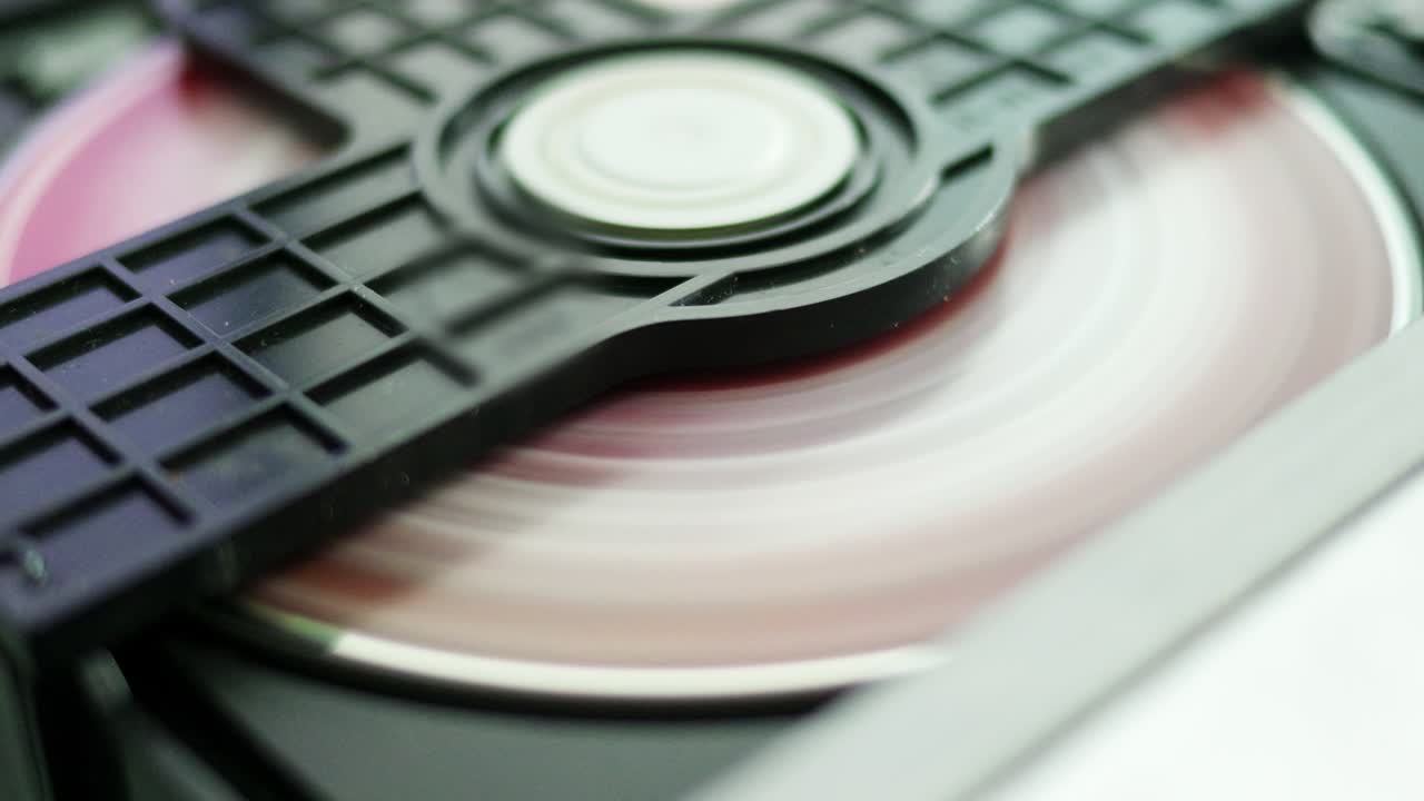 Loading a disc into a cd player home setting close-up shot technological environment