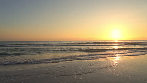 A-golden-idyllic-sunset-as-the-sun-sets-into-the-waters-of-the-gentle-ocean