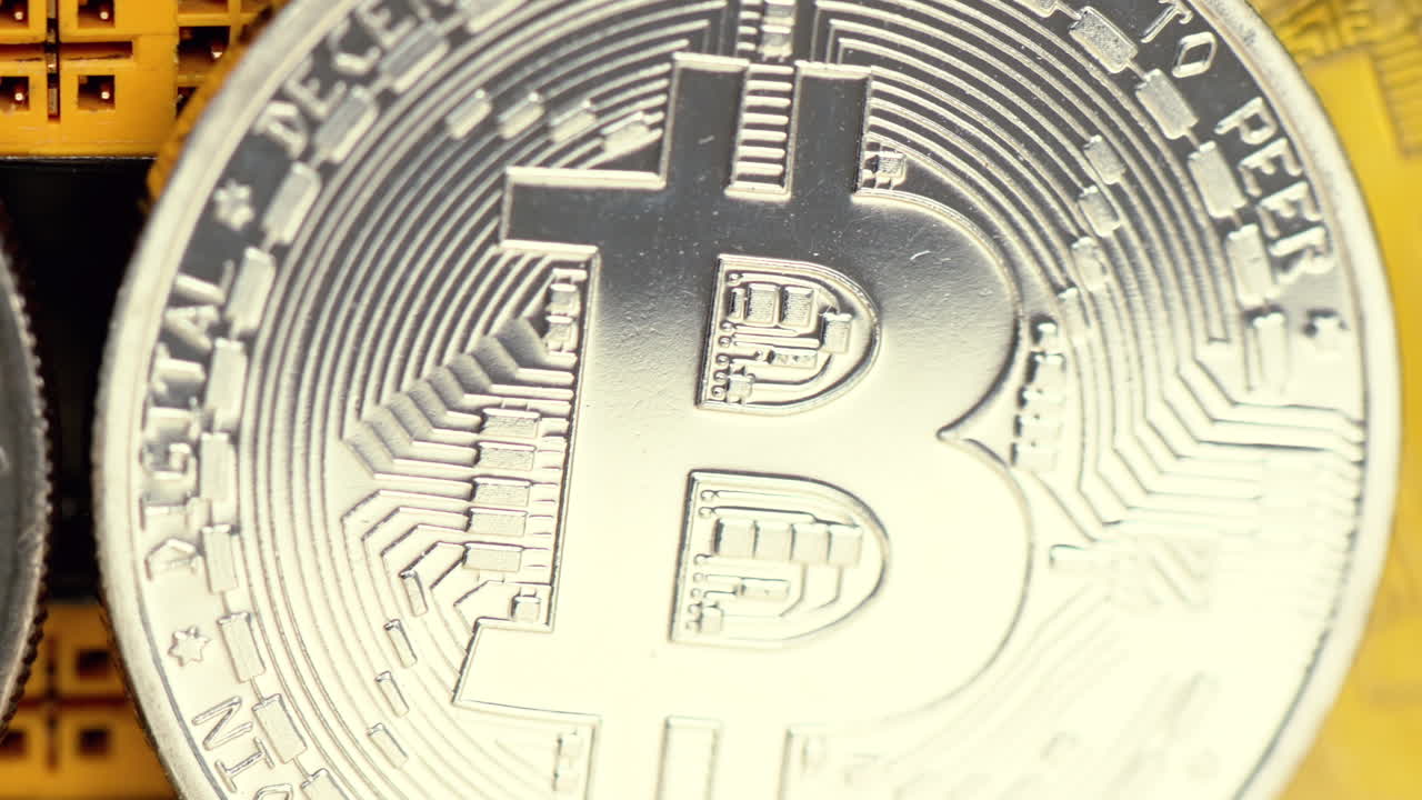 Golden and silver bitcoin crypto money with old dollar coins, close up, graphic video card mining