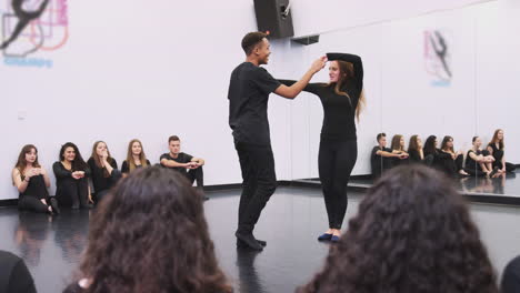 two dance student at performing arts school perform dance for class in studio