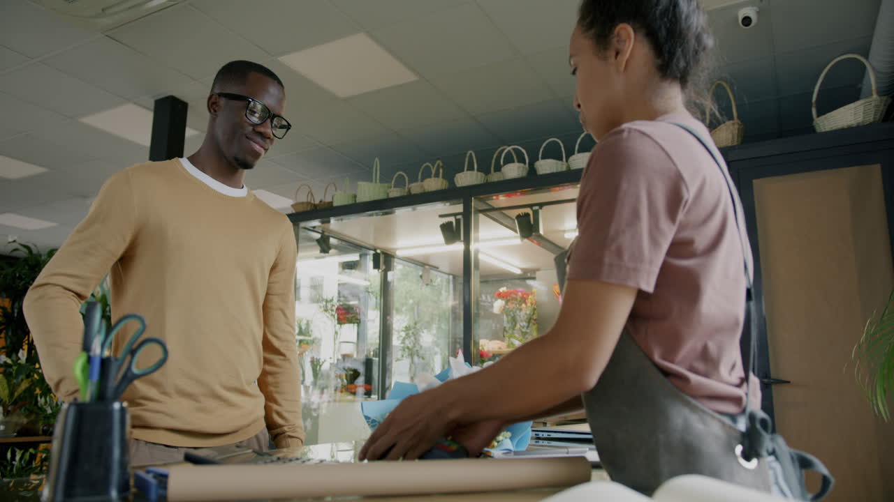Customer paying for flowers in a flower shop