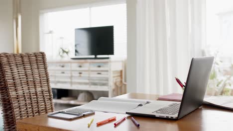 close up of home office table with laptop, calculator and notebook, slow motion