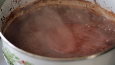 hot, steamy and boiling spicy bbq sauce with red and brown rich dark colors