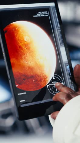 vertical video critical error alert light flashing in spacecraft over helmet next to laptop