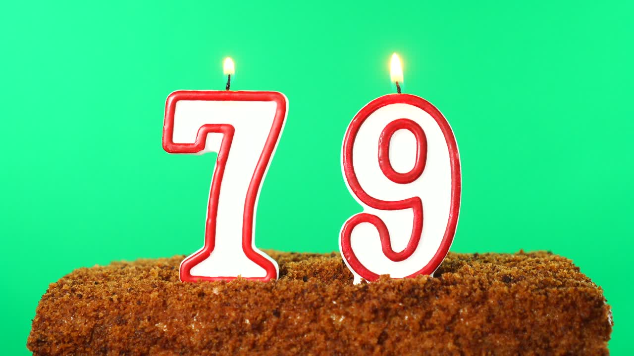 Cake with the number 79 lighted candle. Chroma key. Green Screen. Isolated