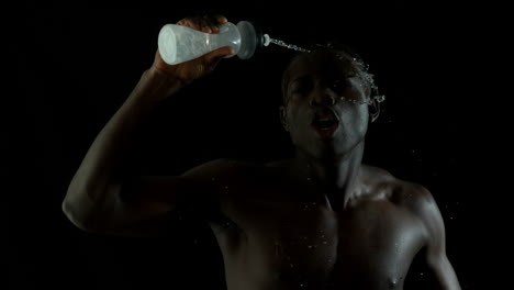 Shirtless-man-jogging-and-pouring-water-over-himself