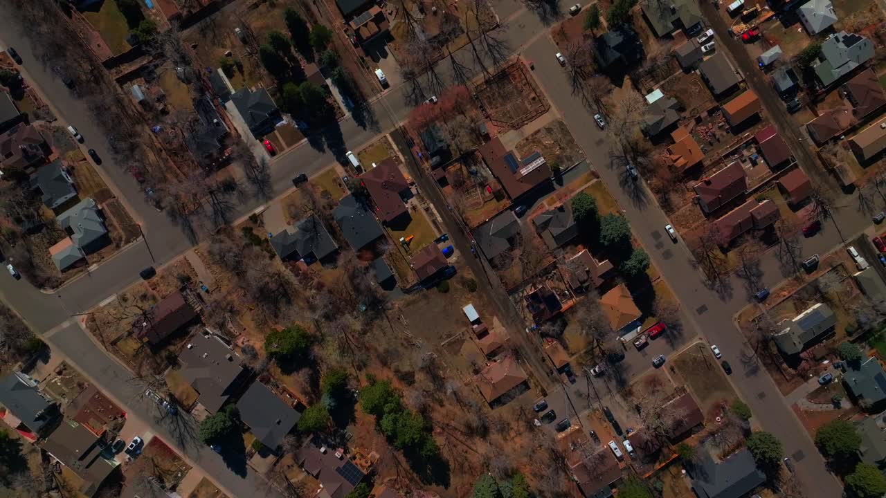 Birdseye aerial drone view perspective downtown Golden Colorado neighborhood buildings streets homes winter sunny daytime Denver front range Morrison Boulder upwards motion