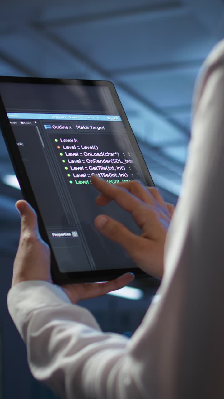 Developer Scrolling and Tapping Code on Digital Tablet Screen
