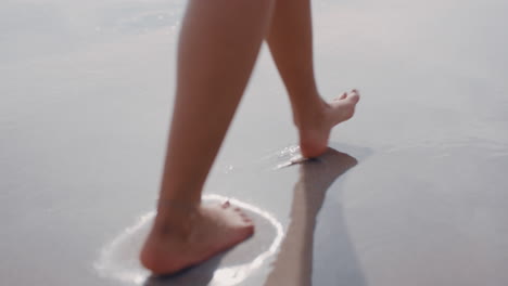 close up woman feet walking barefoot on beach enjoying gentle wet sea sand female tourist on summer vacation