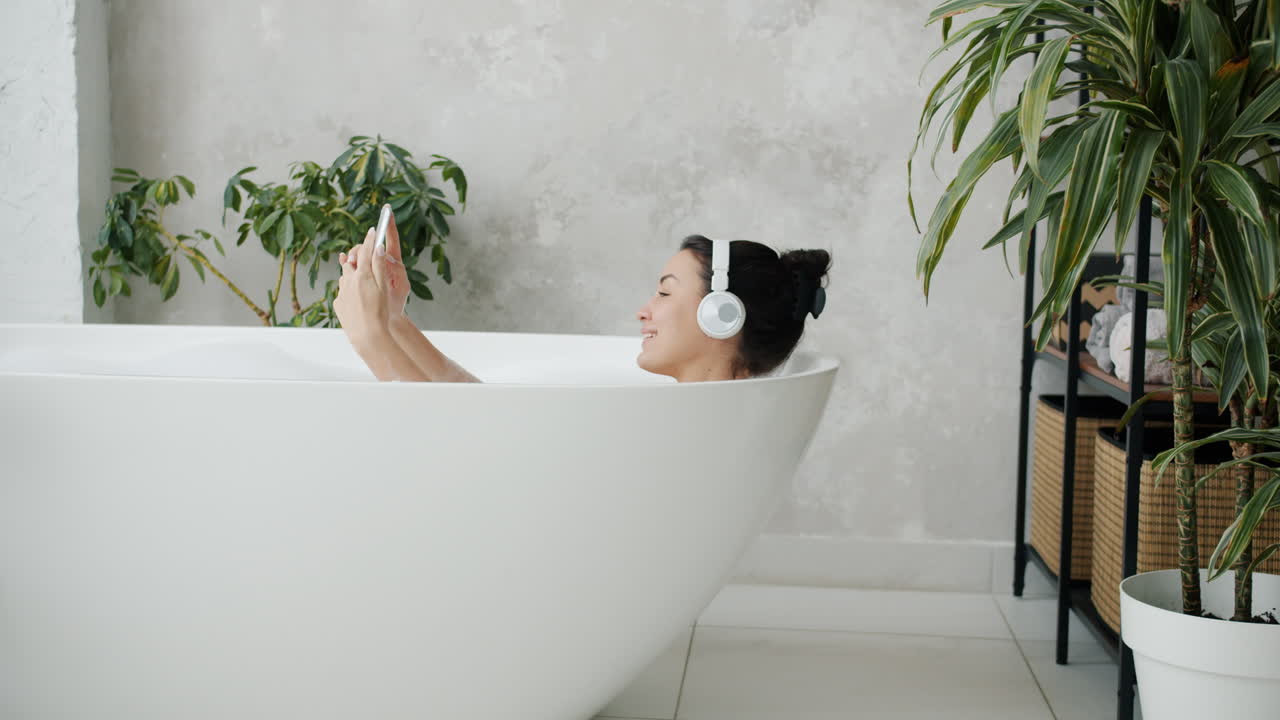 Woman Taking a Selfie in a Bathtub with Headphones